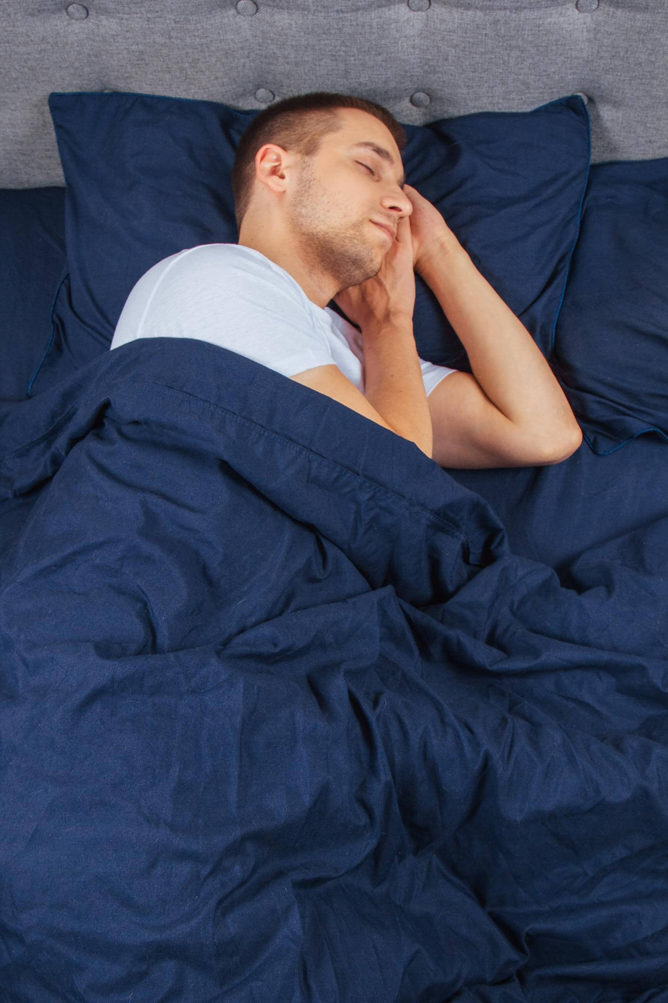top-view-handsome-young-man-sleeping-comfortably-bed-night-his-bedroom-sleep-different-positions-bachelor-bedroom-deep-sleep