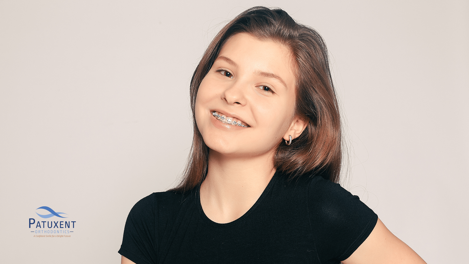 This is an image of a young teenage girl smiling with braces