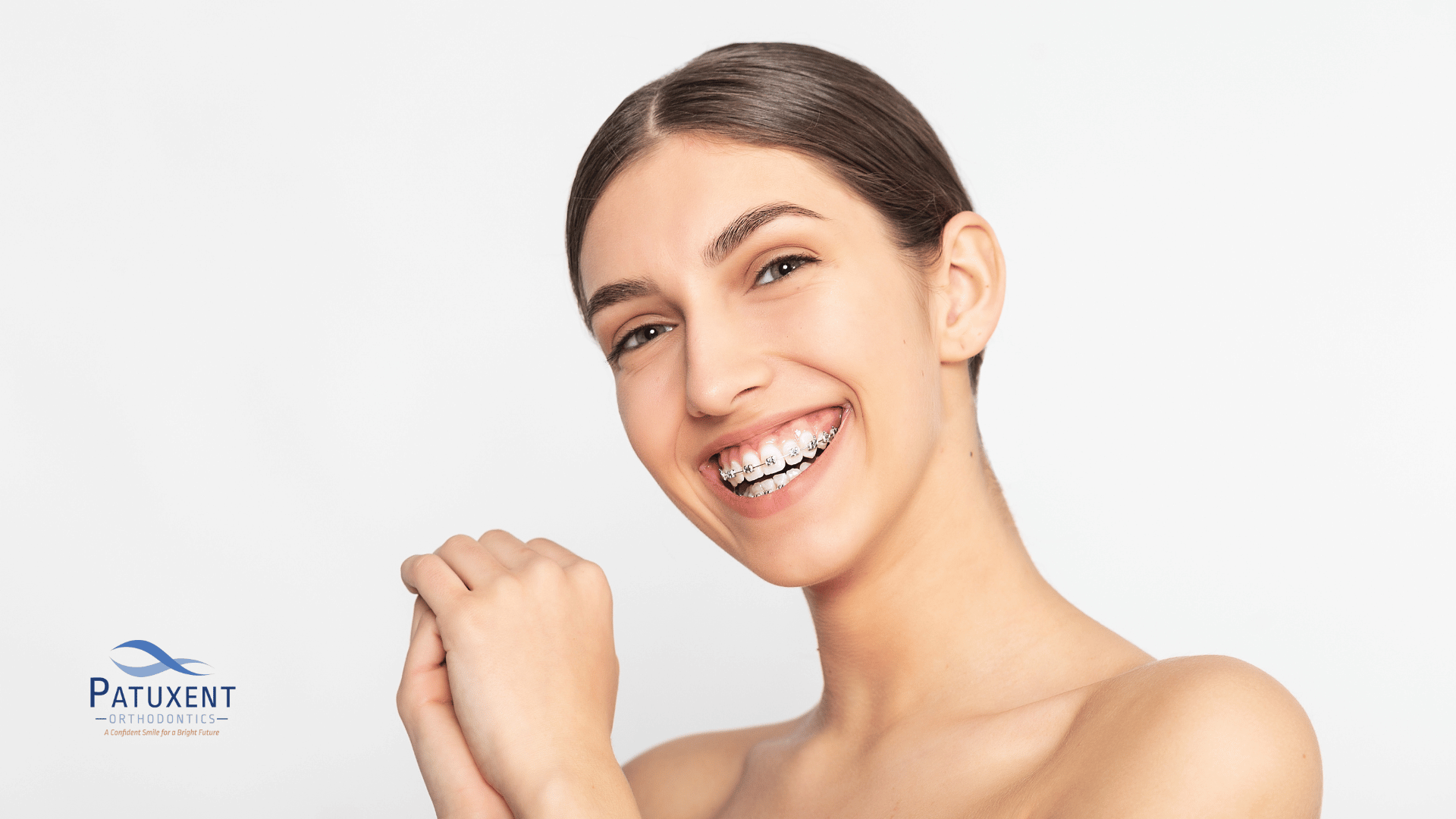 Young woman smiling with braces