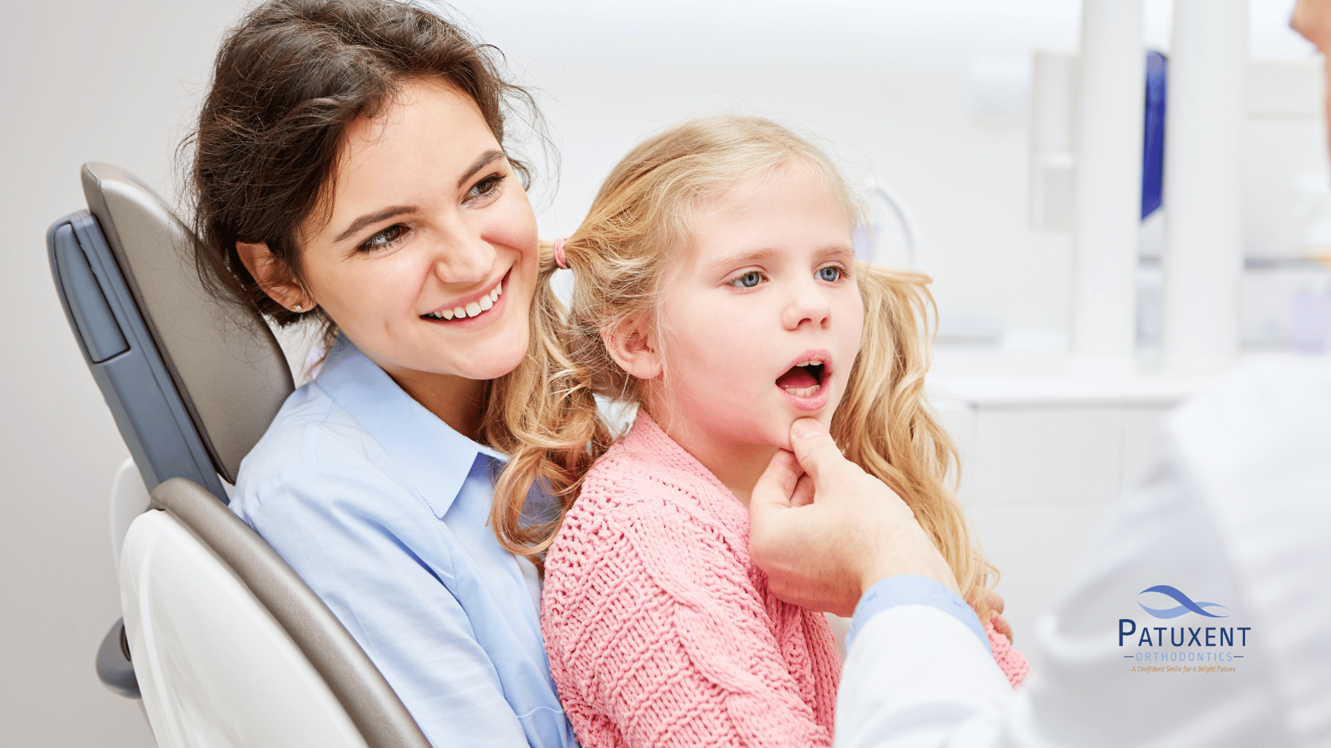 This is an image of a young girl undergoing medical consultation while sitting on her mother’s lap This is an image of a young girl undergoing medical consultation while sitting on her mother's lap